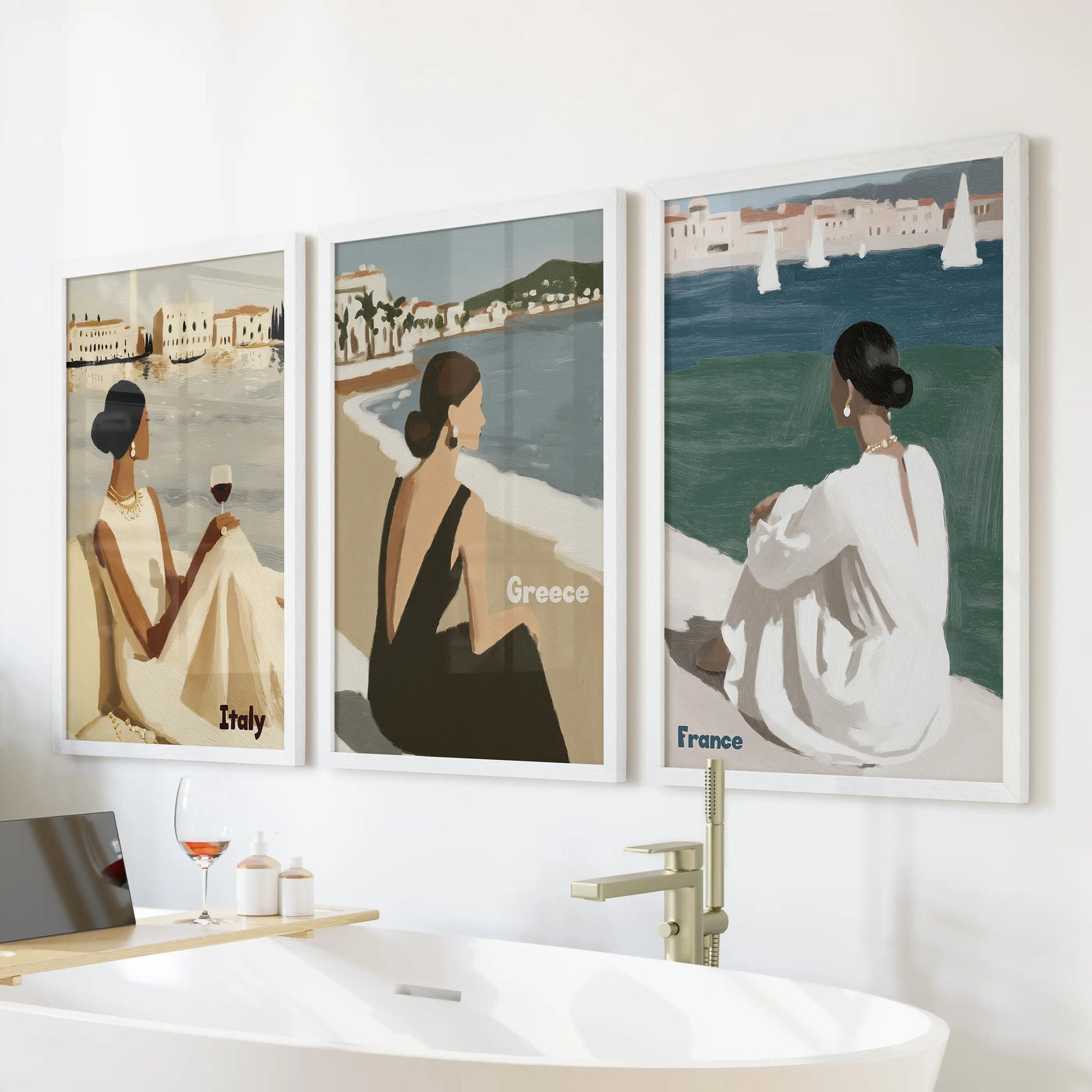 This gallery trio of Mediterranean women art prints in white frames hangs above the bath, filling the room with sunny, unhurried charm.