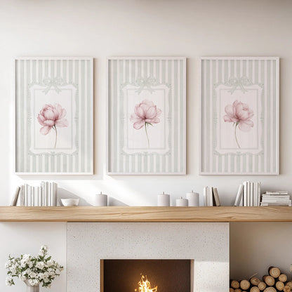 Set of three floral wall art prints in white frames, featuring pink peonies on sage green stripes above a lounge mantelpiece.