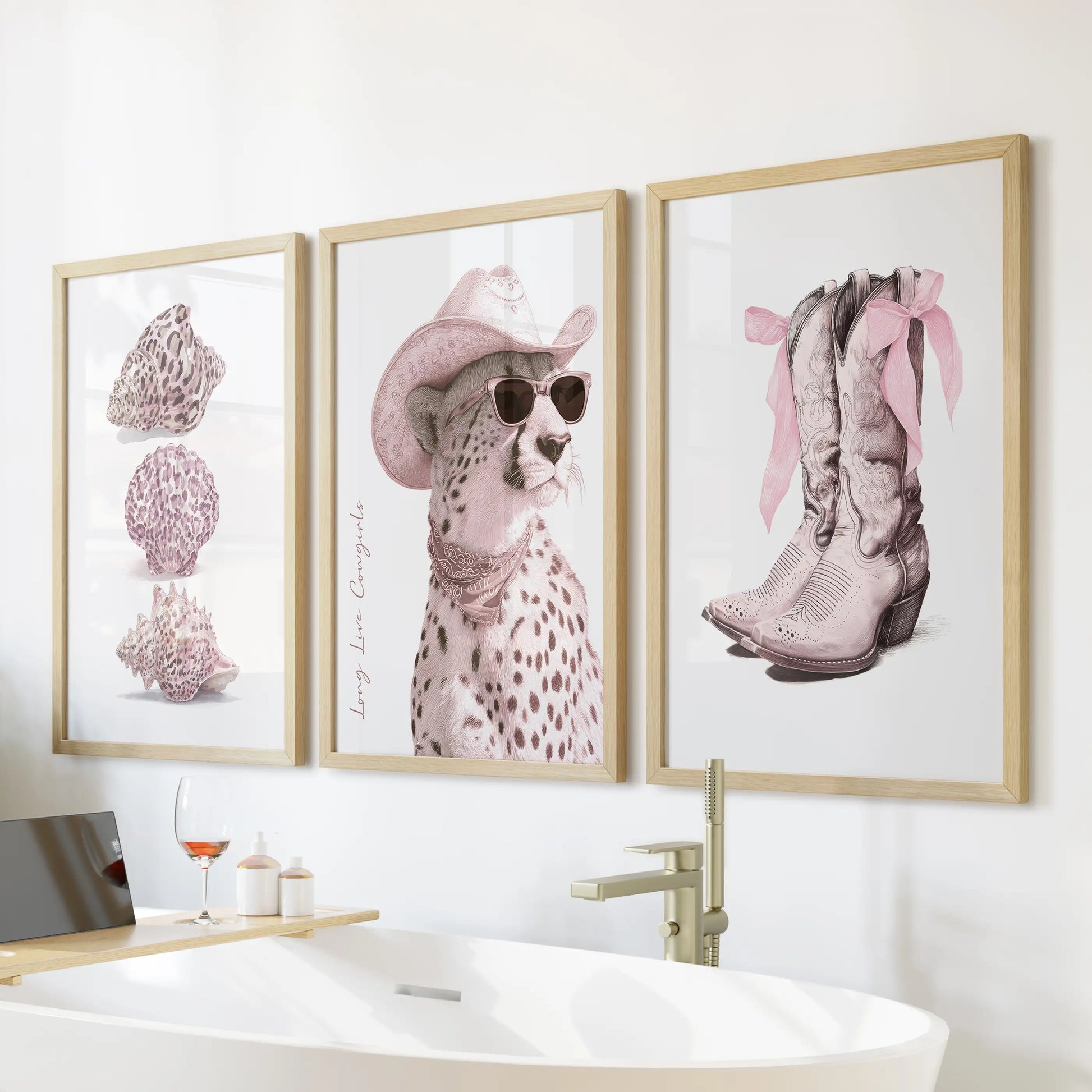 Cowgirl boots and bows three-piece wall art in thin wood frames warms a bathroom above the soaking tub with blush tones and flirty Western charm.