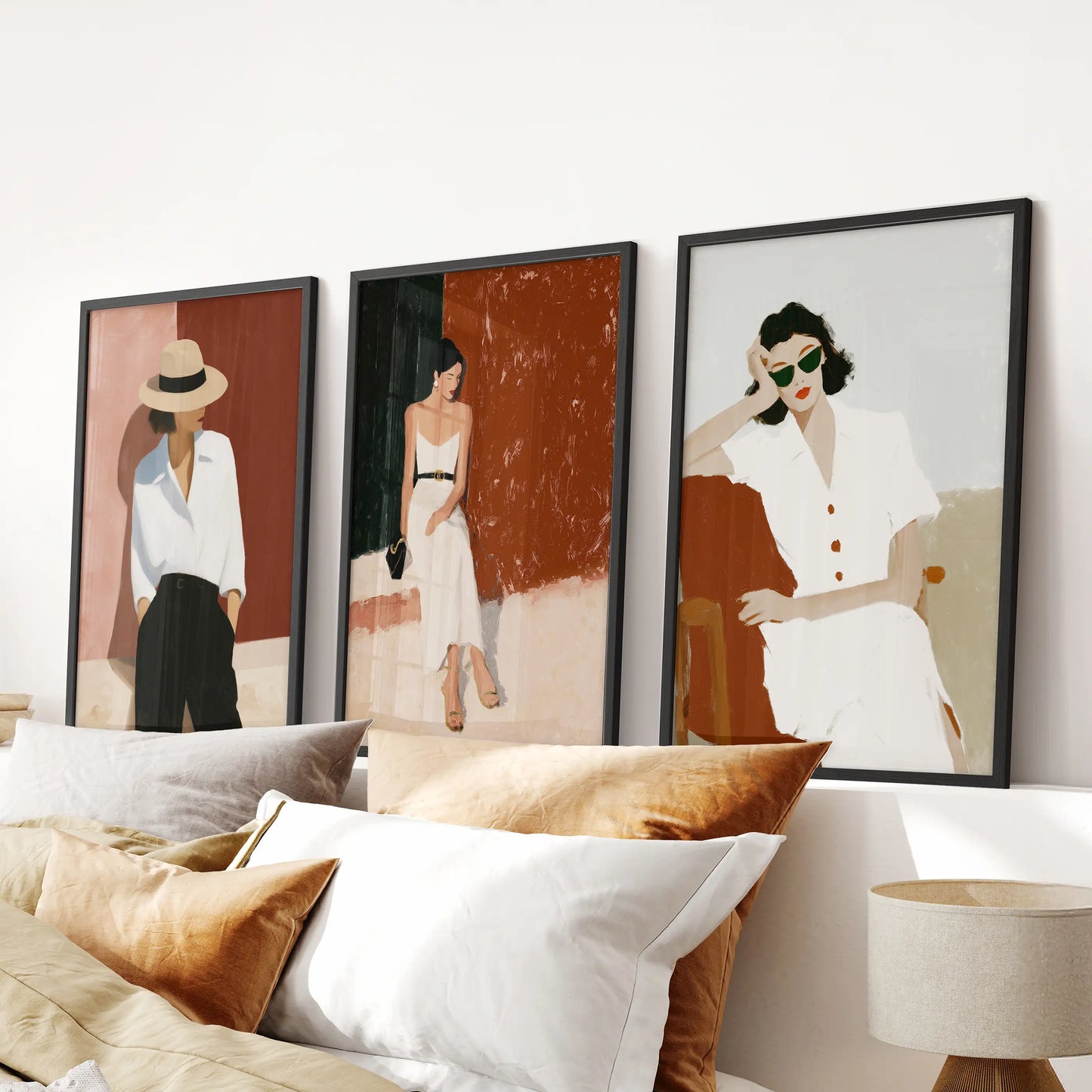 Empowered female figures, a 3-piece wall hanging set, spans above the bed headboard; black framed prints lend confident style to the bedroom.