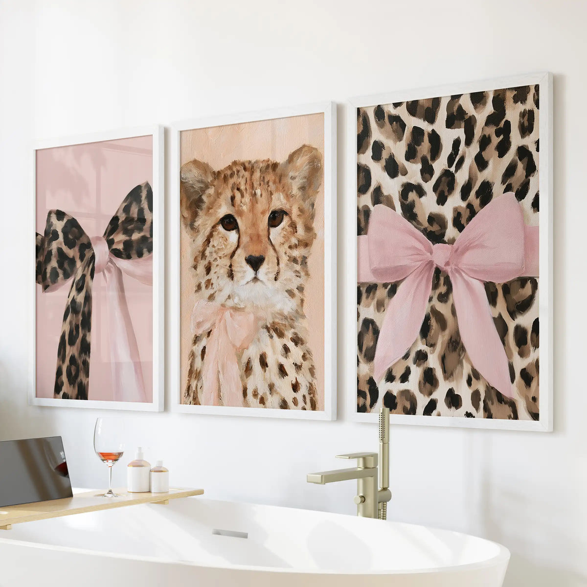 Pink bow leopard portraits, a 3-print wall art bundle in white frames, perched above the tub wall to freshen a bright, feminine bath.