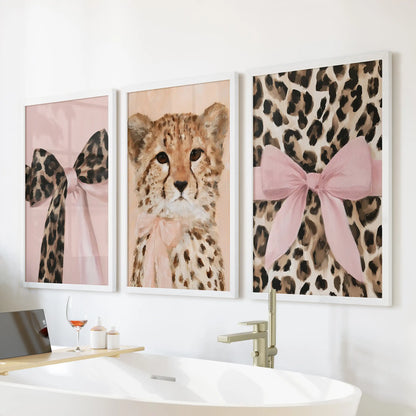 Pink bow leopard portraits, a 3-print wall art bundle in white frames, perched above the tub wall to freshen a bright, feminine bath.
