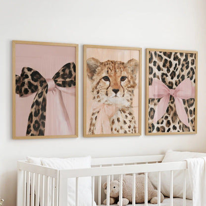 Cheetah and leopard art trio, a three-piece gallery in slim wood frames, floating above the cot to add gentle, friendly energy to the infant room.