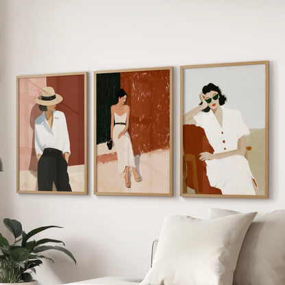 Empowered female figures, a set of three wall prints in natural wood frames, sweep above the sectional sofa to anchor the sitting room.