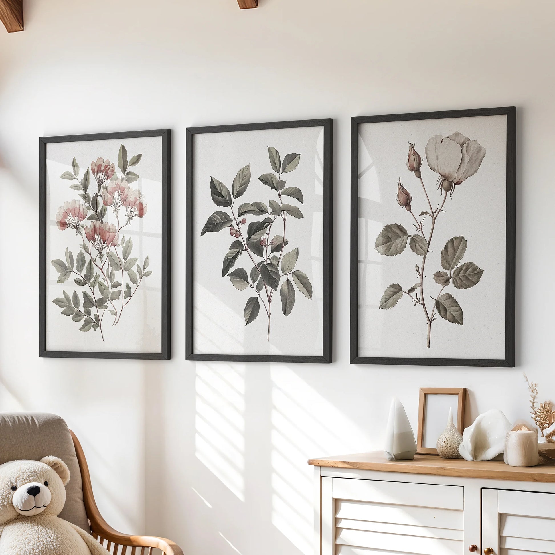 Vintage botanical flower prints, a three-piece wall art set, hang over the chest of drawers in a kids playroom in slim black frames for a cozy, curated feel.