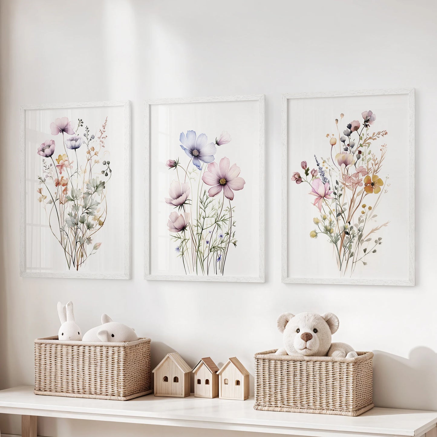 Cottagecore floral prints, a set of three, come in a crisp white frame set and line up over toy storage, adding gentle garden color to a children's room.