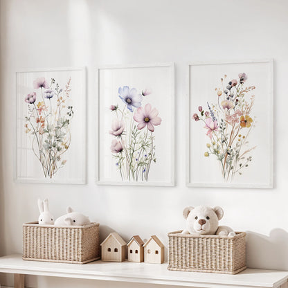 Cottagecore floral prints, a set of three, come in a crisp white frame set and line up over toy storage, adding gentle garden color to a children's room.