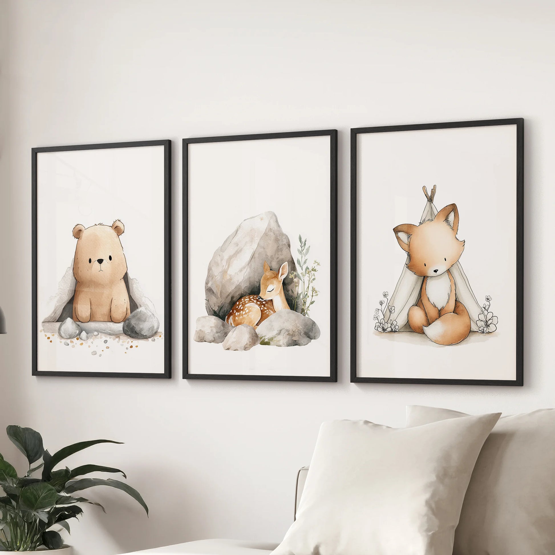 Black framed baby animal portraits, shown as a 3-piece wall set, lend gentle woodland charm over the couch in the sitting room.