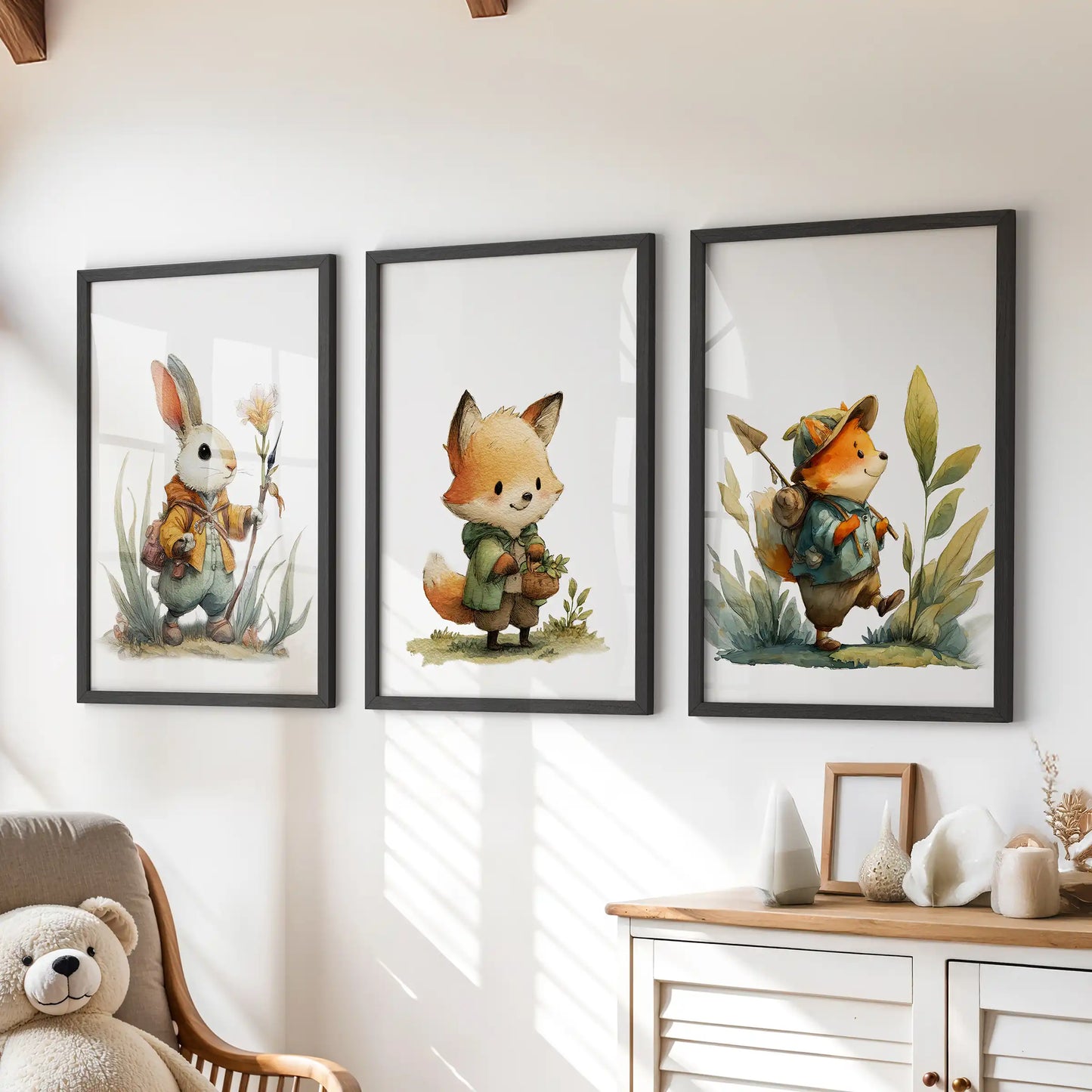A trio of black-framed wall prints featuring woodland fox and bunny art hangs neatly above a kids’ playroom dresser.