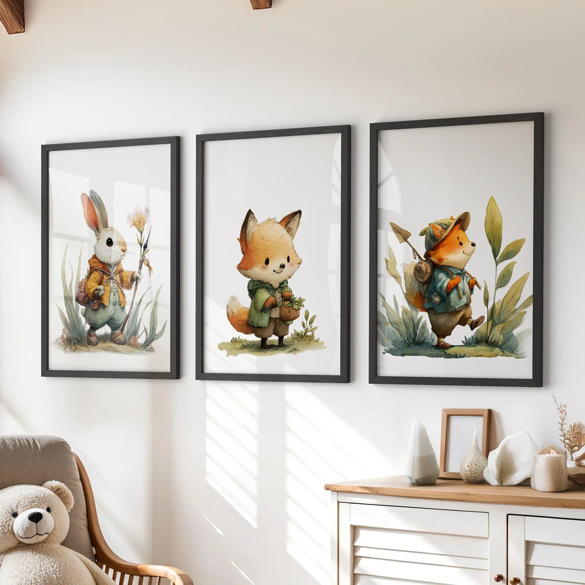 A trio of black-framed wall prints featuring woodland fox and bunny art hangs neatly above a kids’ playroom dresser.
