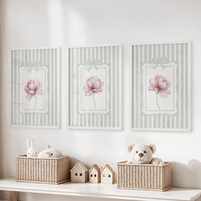 Vintage floral print trio in white frames, featuring pink peonies against sage green stripes over a storage bench in a kids room.
