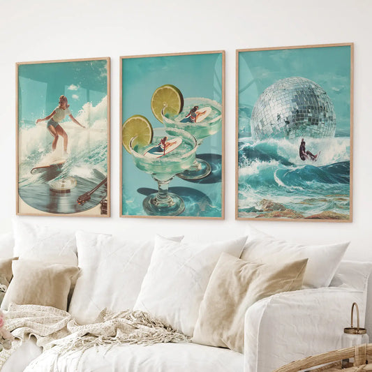Retro wall art set of 3 with surfing girl, ocean waves, and margarita glass surfboards. Thinwood frames over the couch.
