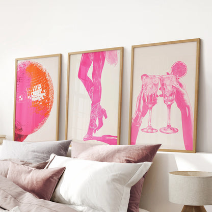 Hot pink abstract prints, a wood-framed set of three above the headboard, energize the pink bedroom with a bold, modern splash.