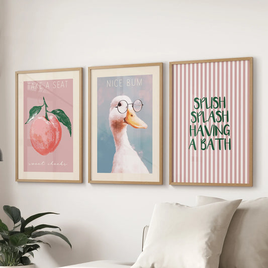 Retro maximalist bathroom posters, a 3-print set for the wall in natural wood frames, styled above the couch to lend a bold, quirky focal point.