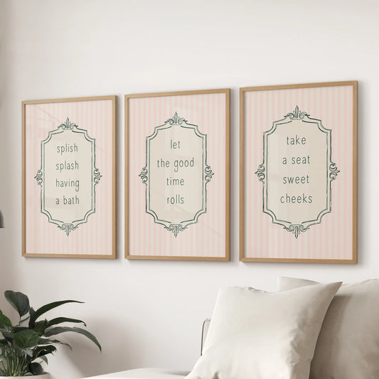 Light pink toilet humor art, a three-piece set in oak frames, caps the family room wall above the couch.