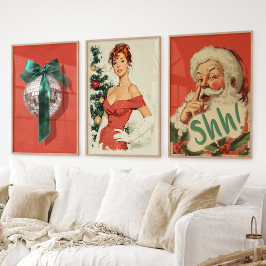 Retro Christmas wall art set of 3 with disco ball, pin-up girl, and Santa print. Thinwood frames over the couch.