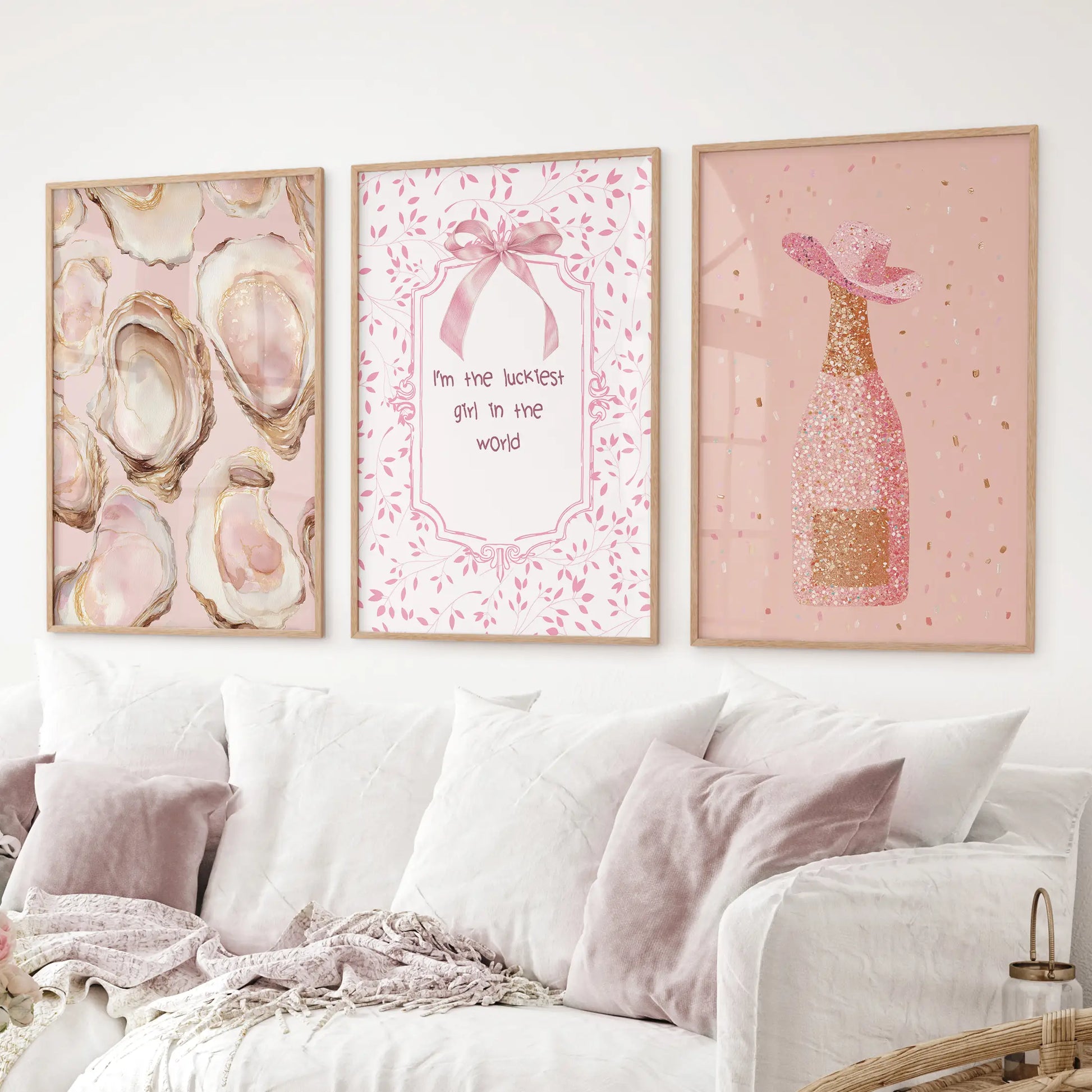 Playful pink aesthetic wall prints – champagne sparkle, oyster shells, and girly quote. Thinwood frames above the sofa.