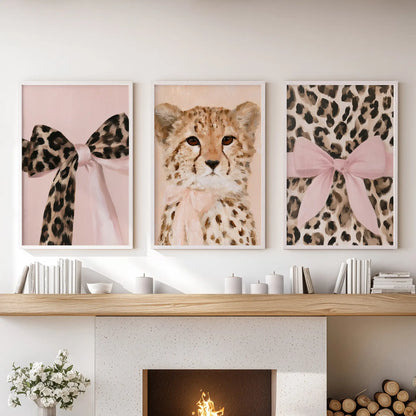 Three white-framed art prints with preppy coquette animals sit over the mantelpiece, bringing a light, polished lift to the living room.