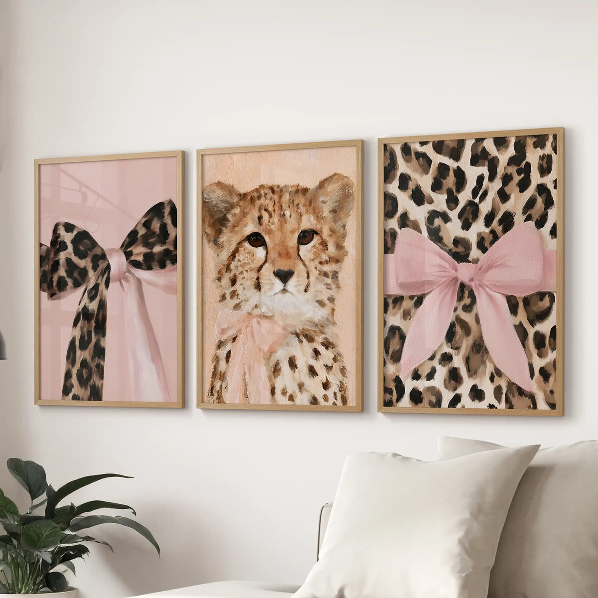 A three-piece framed wall art set of leopards and cheetahs hovers in oak frames above the sectional, anchoring the sitting room with playful glam.