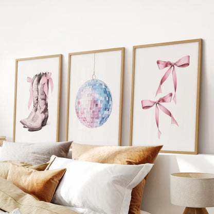 Girly preppy print set of three wall decor pieces, in light oak frames, tops a pink bedroom headboard with breezy coastal color and playful polish.