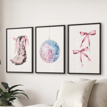 A pink-and-blue wall decor trio with sleek black frames styles the lounge above the couch, giving it an easy preppy-coastal feel.