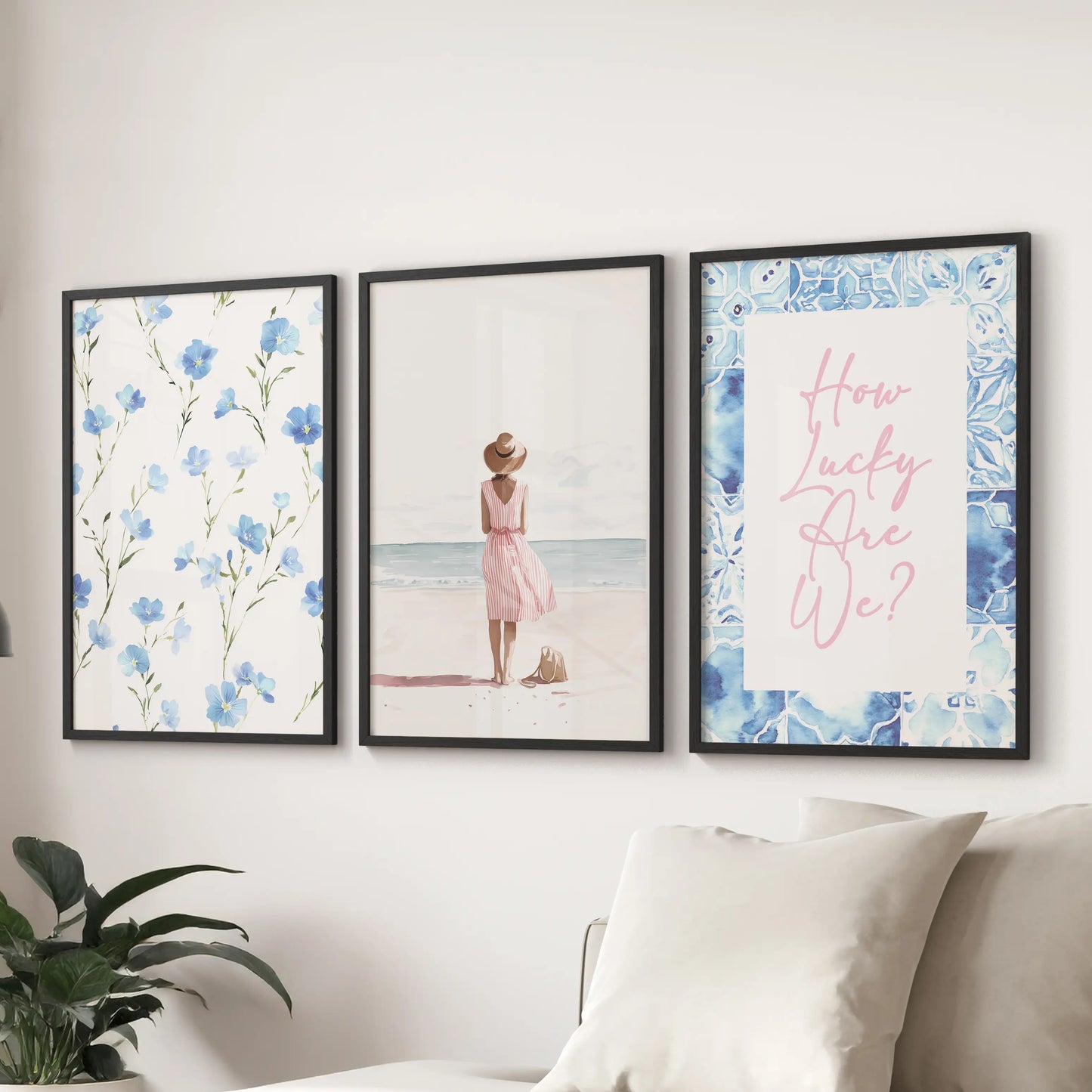 Pastel blue coastal prints, a 3-piece wall art set, arrive in sleek black frames and hang above the couch to freshen a relaxed sitting room.