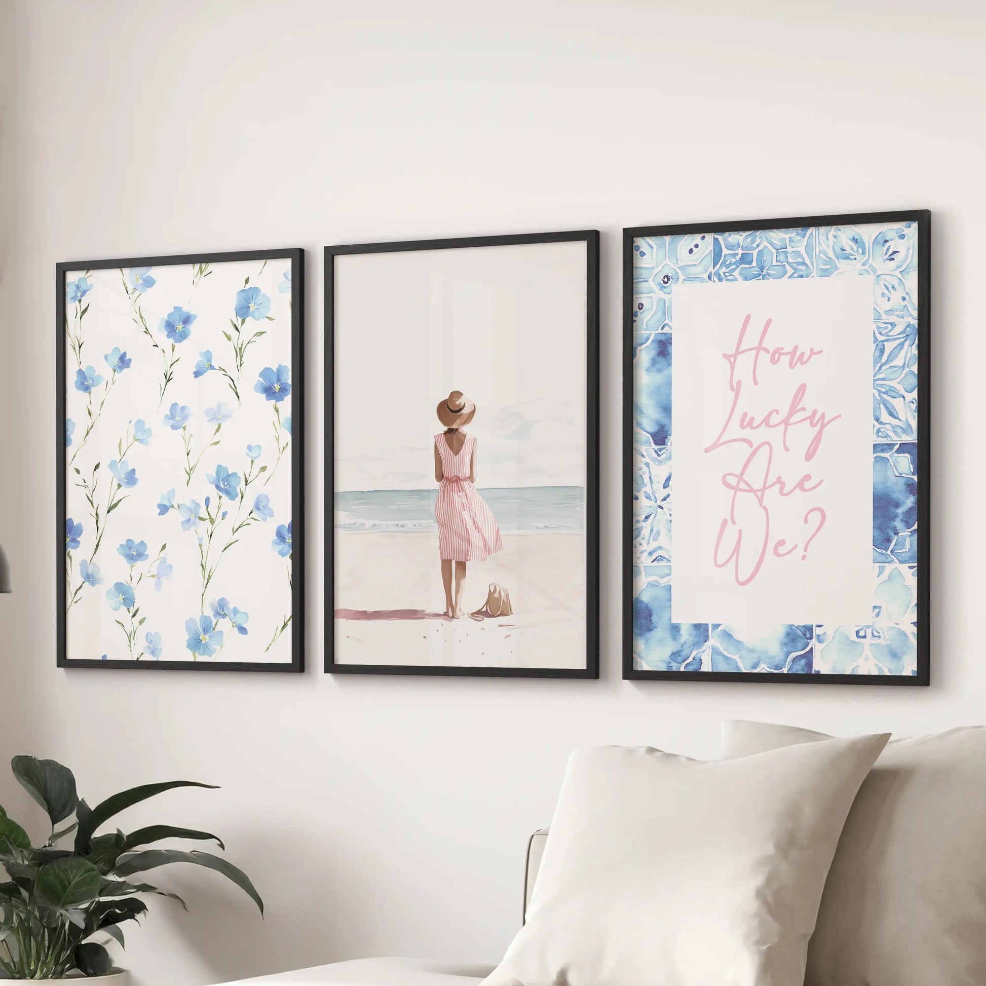 Pastel blue coastal prints, a 3-piece wall art set, arrive in sleek black frames and hang above the couch to freshen a relaxed sitting room.