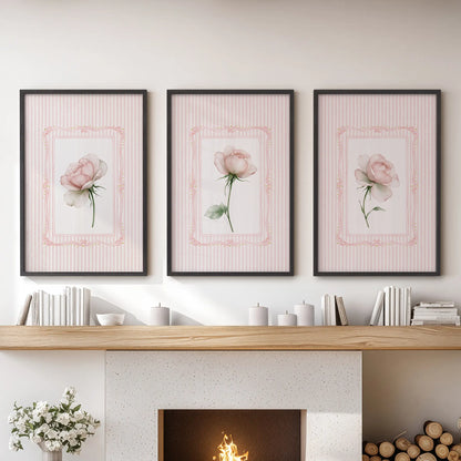Three-piece floral bouquet wall art set in black frames, displayed over the hearth in a family room.