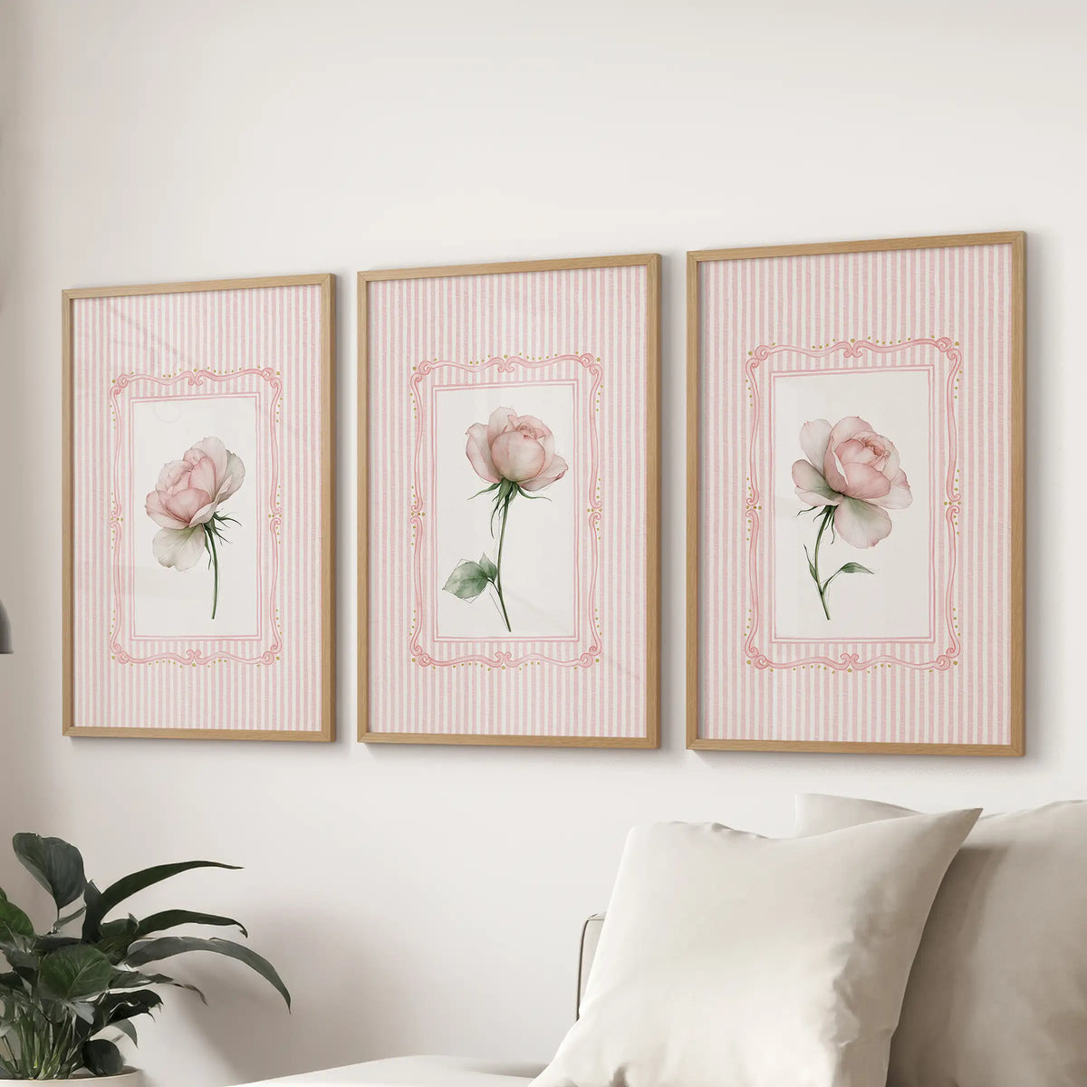 Set of three floral bouquet wall art prints in light wood frames, displayed above a sectional sofa in the family room.