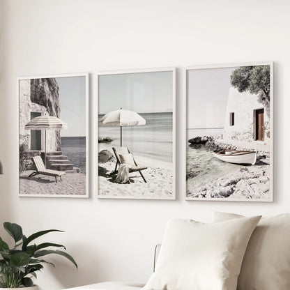 Mediterranean beach photography, a 3-piece art print set hung over the sofa in the sitting room, finished in white frames for a clean coastal look.