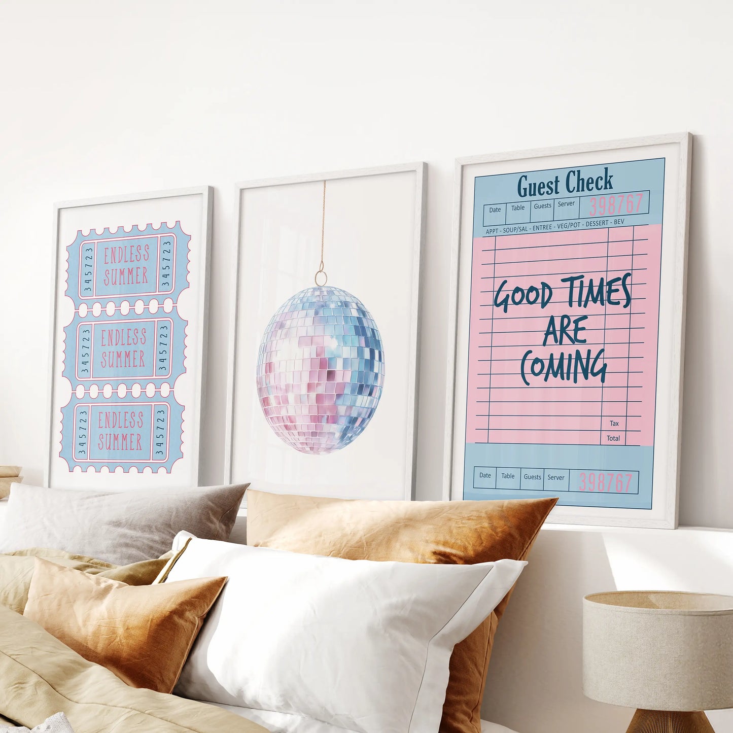 Above the bed, this white-framed set of three coastal prints features a guest check, disco ball, and beach ticket in preppy blue and pink tones.