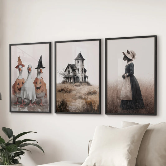 Three-piece ghost artwork in sleek black frames drifts over the sectional sofa, giving the family room a lighthearted spooky accent.