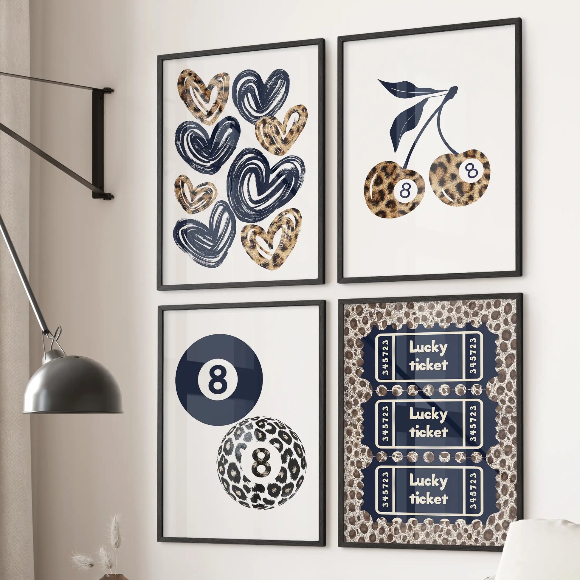 Hearts wall art set of four in black frames hangs behind the couch in a cozy living room, mixing cherries, an 8 ball, and a lucky ticket over blue cheetah patterns.