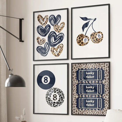 Hearts wall art set of four in black frames hangs behind the couch in a cozy living room, mixing cherries, an 8 ball, and a lucky ticket over blue cheetah patterns.