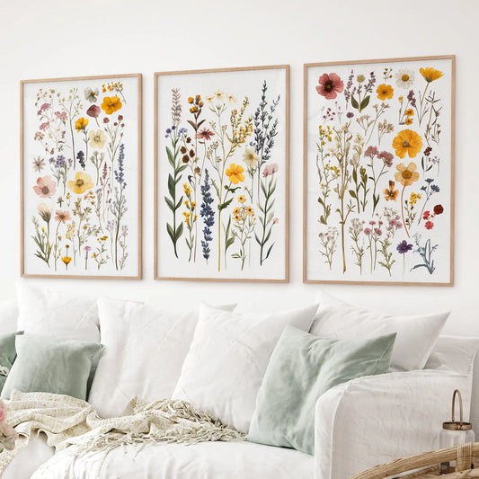 Set of 3 vintage wildflower prints with colorful botanical illustrations. Thinwood frames over the couch.