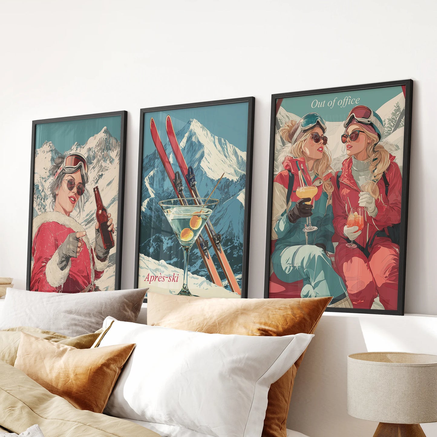 Three apres-ski wall art prints in sleek black frames bring cozy holiday charm to the bedroom, styled just above the headboard.