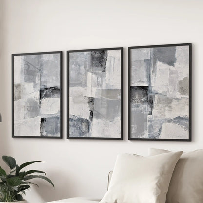 This three-piece wall art of soft gray brushstroke studies sits above the sitting room sofa, crisply outlined in black frames.