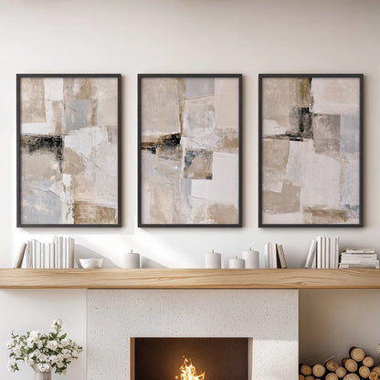 Three framed wall artworks form a neutral Japandi triptych above the family room hearth, set off by understated black frames.