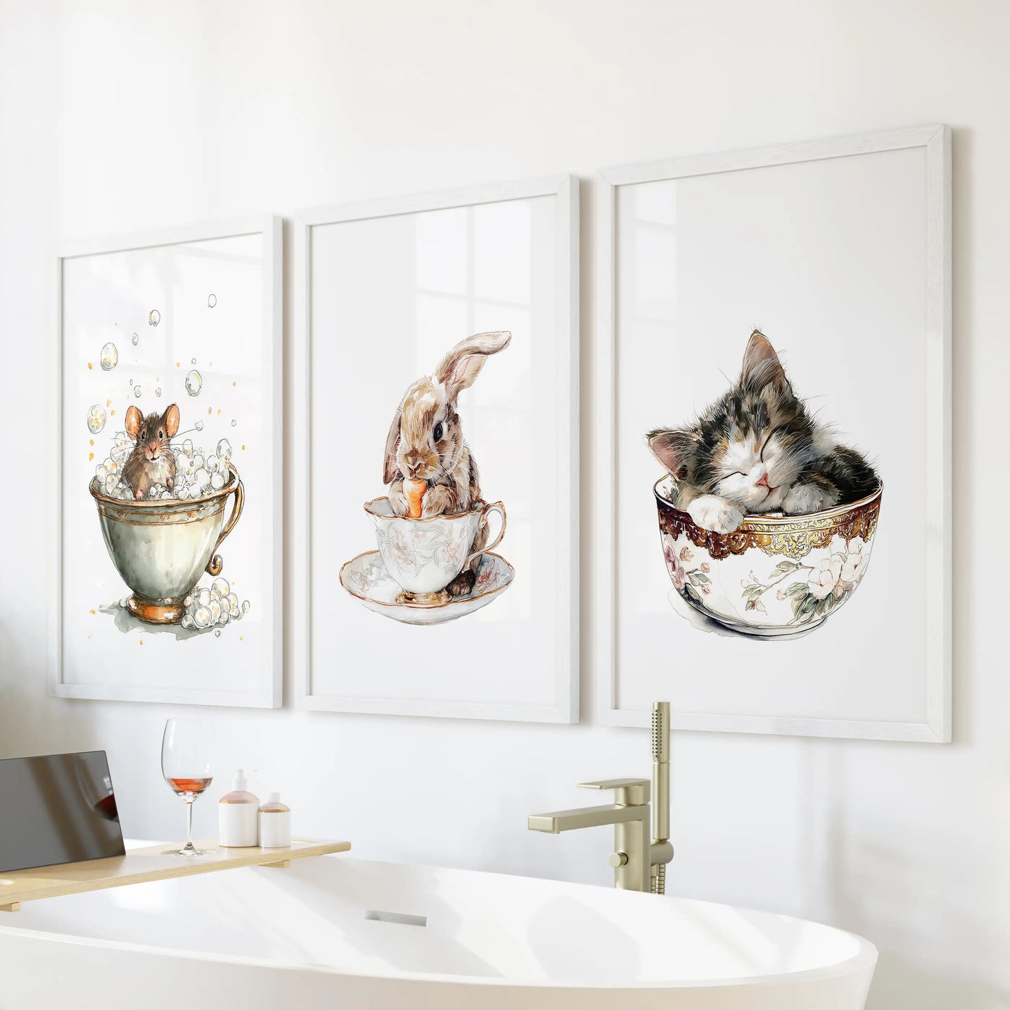 A white-framed trio of wall art showing a sleepy kitty in a cup perches above the tub, watercolor tones easing the bathroom’s mood.