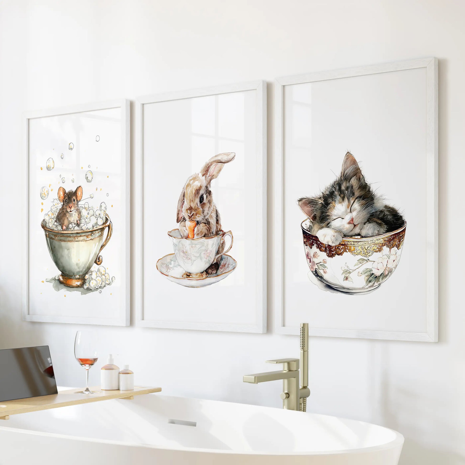 A white-framed trio of wall art showing a sleepy kitty in a cup perches above the tub, watercolor tones easing the bathroom’s mood.