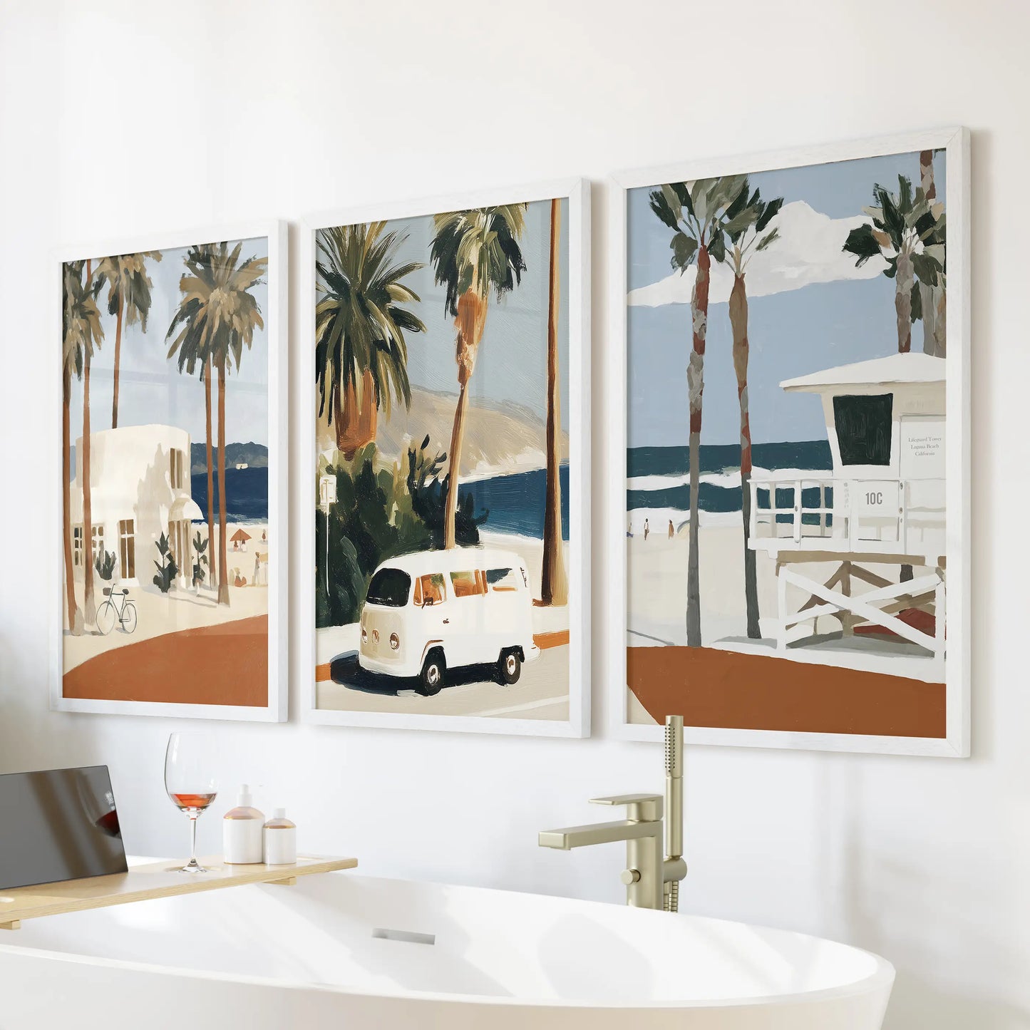 A trio of white-framed ocean wave photos brings gentle motion to the bathroom, arranged neatly above the bathtub wall.