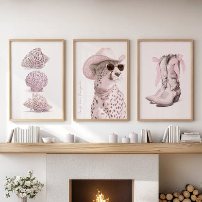 Seashells three-print gallery set in oak frames graces a lounge above the fireplace mantel, bringing sunlit coastal texture to the space.