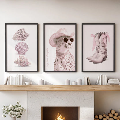This three-piece pink leopard print set in black frames tops a lounge mantel, mixing gentle blush tones with crisp contrast for an elegant highlight.