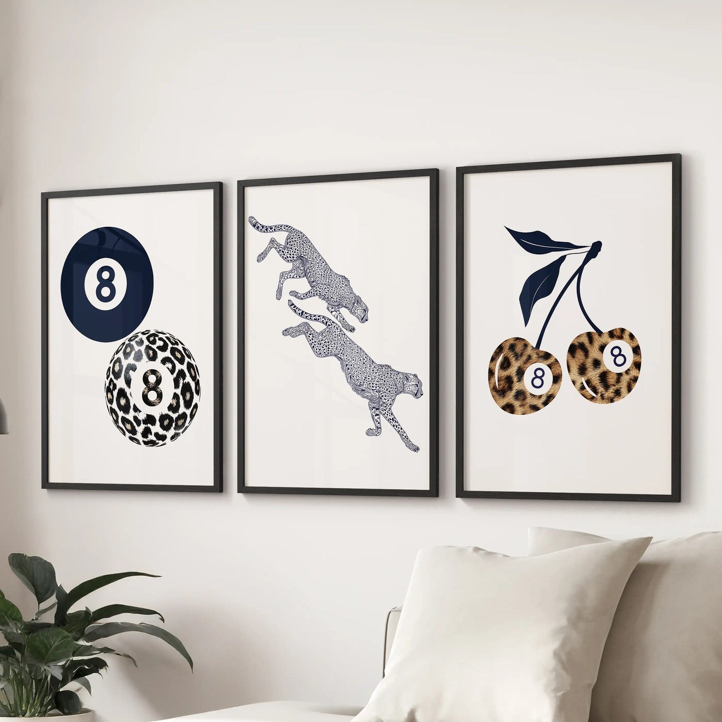 Set of three navy cheetah art prints in black frames anchors the living room wall above the sectional with crisp modern style.