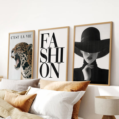 Leopard luxury art poster wall art trio in thin wood frames, hung above the headboard to bring texture and flair to a chic bedroom.