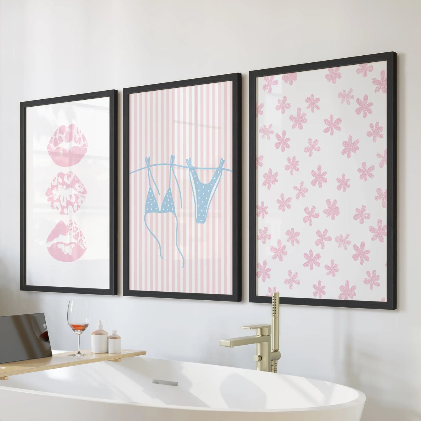 Pastel pink and blue coastal scenes, set of three wall art, styled above the soaking tub in sleek black frames for a breezy, beachy bathroom.
