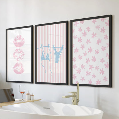 Pastel pink and blue coastal scenes, set of three wall art, styled above the soaking tub in sleek black frames for a breezy, beachy bathroom.