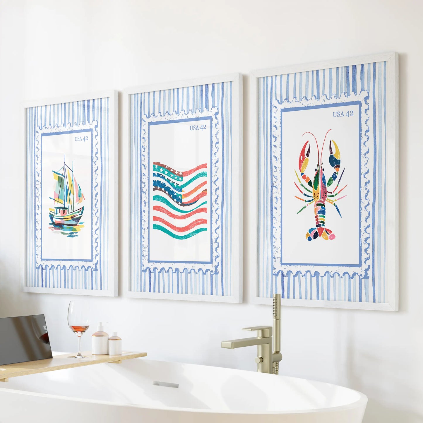 This set of three coastal wall prints showing a lobster boat and flag sits in white frames above the tub, bringing relaxed seaside charm.