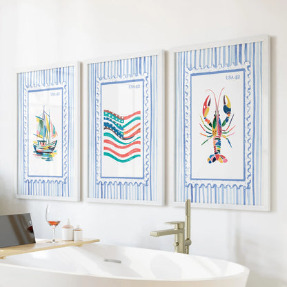 This set of three coastal wall prints showing a lobster boat and flag sits in white frames above the tub, bringing relaxed seaside charm.
