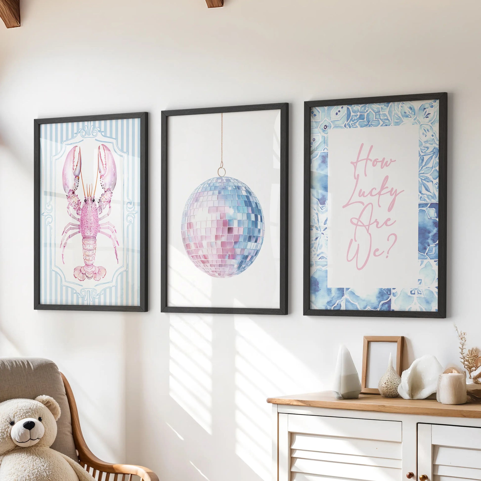 Above the playroom dresser, three disco mirror ball prints in black frames bring a lively, beach-bright sparkle to the kids’ space.